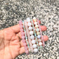 Amazonite Bracelet next to other pink and white gemstone bracelets - Lithos Crystals