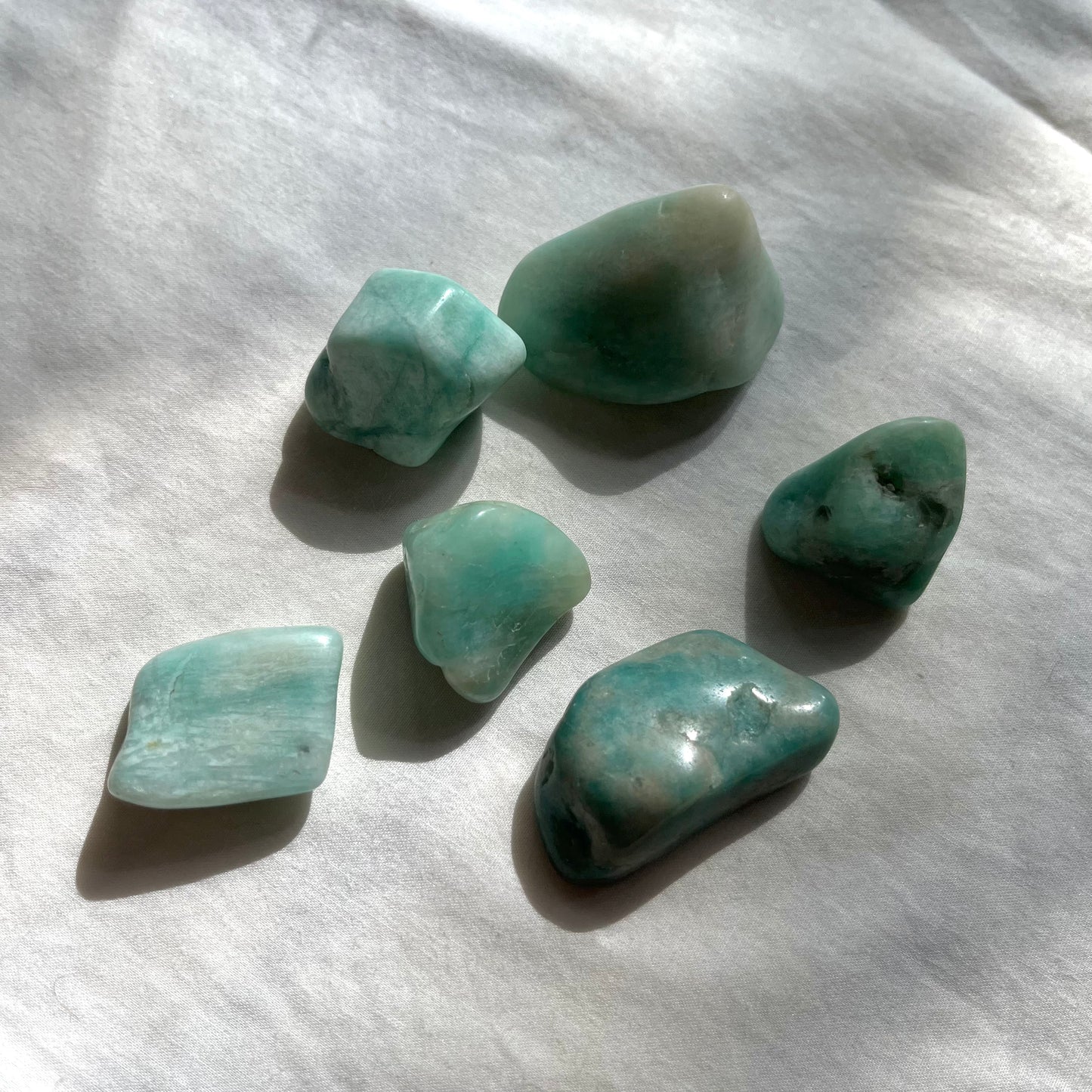 A group of amazonite crystal tumble stones